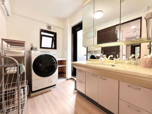 a kitchen with a washer and dryer in it at ManOku in Tokyo