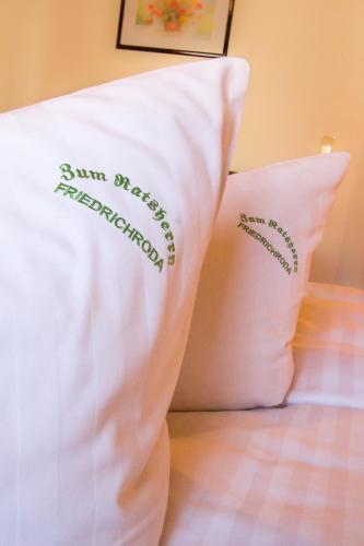 two baseball pillows sitting on top of a bed at Pension Zum-Ratsherrn in Friedrichroda