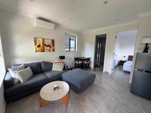 a living room with a couch and a table at Little House with private garden in Padstow