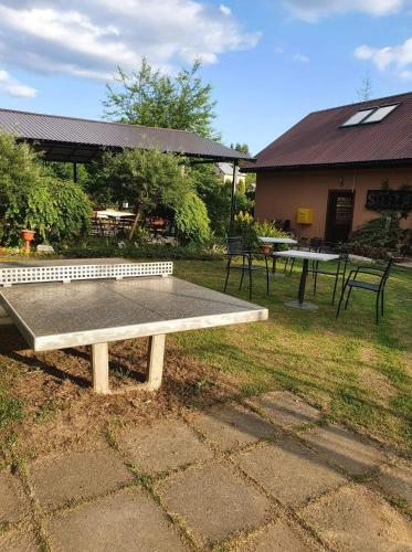 a ping pong table in front of a building with at Całoroczny Domek pod Brzozami in Polańczyk