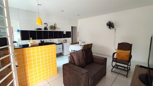 a living room with a couch and a kitchen at Apt perto do shopping in Petrolina