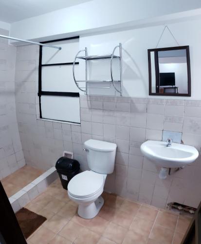 a bathroom with a toilet and a sink at Hostal Cusco de mis Sueños in Cusco