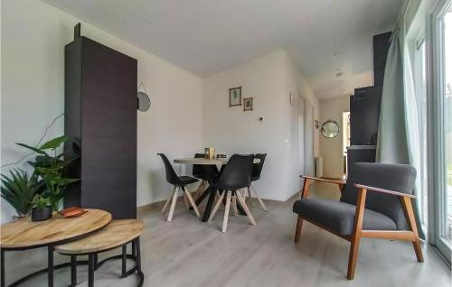 a living room with a table and chairs at Nice Home In Heinkenszand With Wifi in Heinkensand