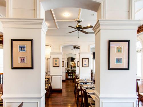 a dining room with white columns and a ceiling at Village Hotel Albert Court by Far East Hospitality in Singapore