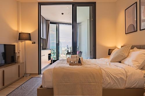 a bedroom with a large bed and a large window at Luxury Condo Edge Central Pattaya in Pattaya