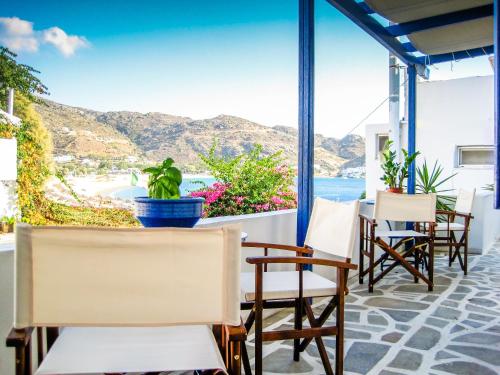 a patio with chairs and a view of the ocean at Drakos Twins in Mylopotas