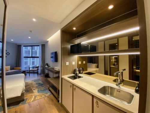 a kitchen with a sink and a bed in a room at Căn hộ biển APEC MANDALA mũi né in Phan Thiet
