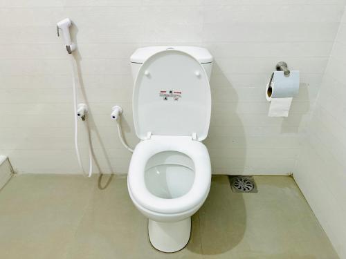 a bathroom with a toilet and a roll of toilet paper at The Blue Sapphire Of Wilpattu in Wilpattu