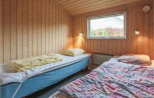 a bedroom with two beds and a window at Holiday Home Strandvænget Slagelse in Strandlyst