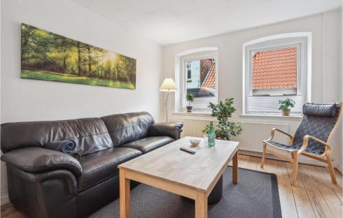 a living room with a leather couch and a coffee table at Amazing Apartment In Sønderborg in Sønderborg