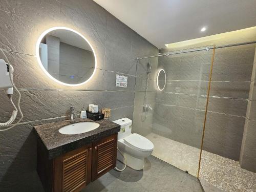 a bathroom with a sink and a toilet and a mirror at ABC HOTEL BÌNH TÂN in Ho Chi Minh City