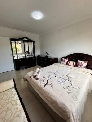 a bedroom with a large bed and a window at Alison's central apartment in Cabramatta