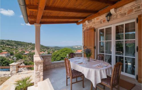 a patio with a table and chairs on a balcony at One-Bedroom Holiday Home In Nerezisca in Nerežišća