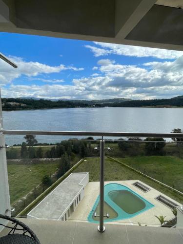 a balcony with a view of a body of water at Náutica Lake Paipa - Penthouse in Paipa