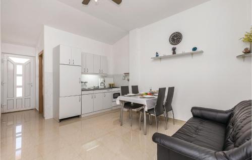 a living room with a couch and a table and a kitchen at 2 Bedroom Awesome Apartment In Povljana in Povljana