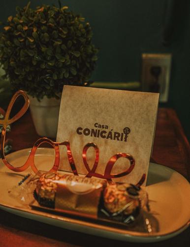 a plate of food on a table with a sign at Casa Conicarit in Puerto Escondido
