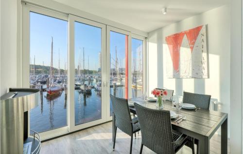 a dining room with a view of a marina at Passatvilla - Apartment 2 in Travemünde