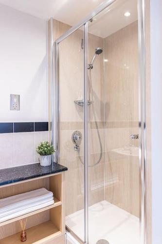 a shower with a glass door in a bathroom at The Lookout in Alnwick