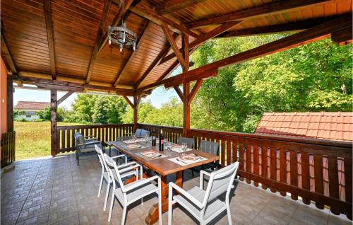 a wooden deck with a table and chairs on it at Gorgeous Home In Mirkopolje With Wifi in Trg