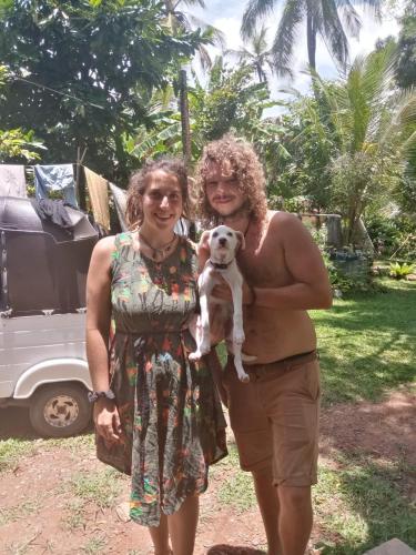 two women standing next to each other holding a dog at Green Valley Home stay in Talpe