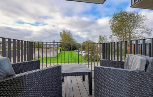 a patio with two chairs and a table on a deck at 2 Bedroom Cozy Apartment In Nordstrand in Nordstrand
