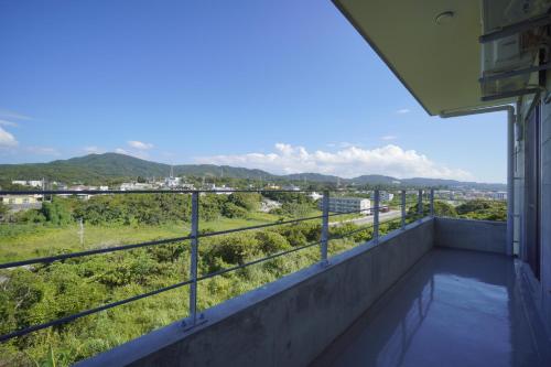a balcony with a view of the city at CondoYumangi in Onna