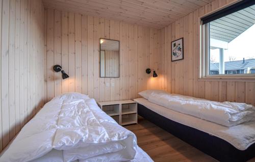 a bedroom with two beds and a window at 8 Bedroom Beautiful Home In Grenaa in Grenå