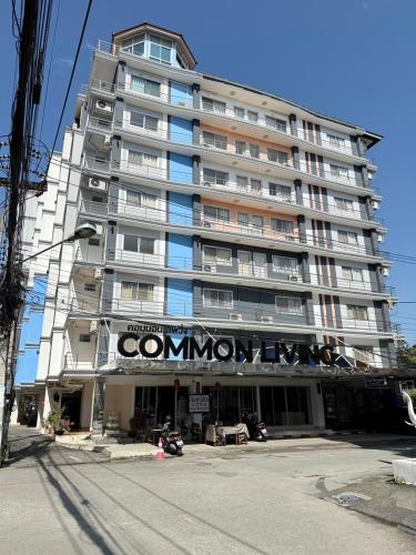 a large apartment building with a sign on it at Common Living in Chiang Mai