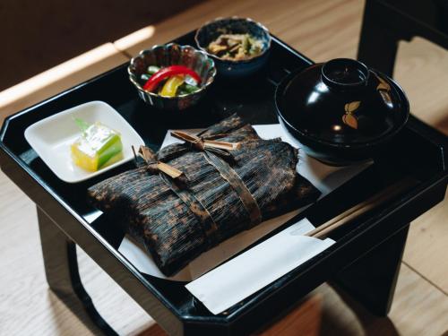 a black tray with a plate of food on a table at RITA Yame Fukushima in Yame