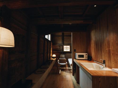 a kitchen with a sink and a microwave at RITA Yame Fukushima in Yame