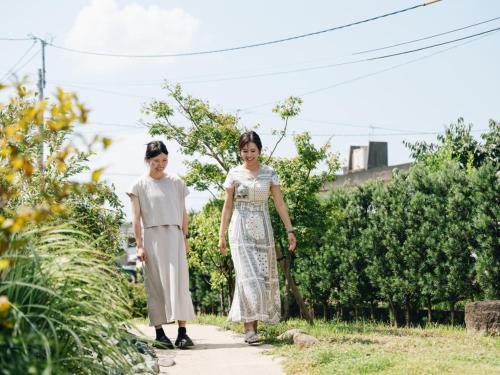 two young girls walking down a sidewalk at RITA Yame Fukushima in Yame