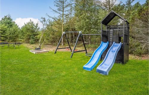 a playground with a slide and a swing at Stunning Home In Ringkøbing With Sauna in Søndervig