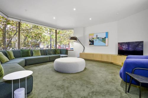 a living room with a couch and a table at Bourke Street Urban Retreat in Melbourne