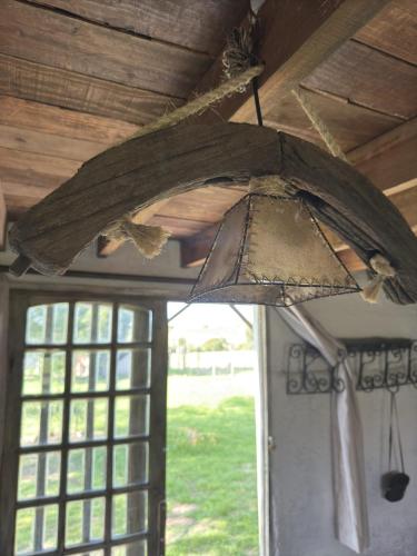 an umbrella hanging from the ceiling of a room at Alquilo casa en las Sierras de Minas "VIEJO RANCHO" in Minas