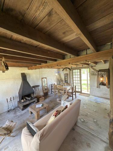 a large living room with a couch and a fireplace at Alquilo casa en las Sierras de Minas "VIEJO RANCHO" in Minas
