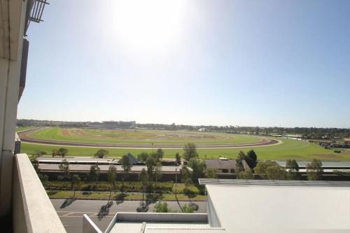 a view of a race track from a building at The Gallop Kensington in Melbourne