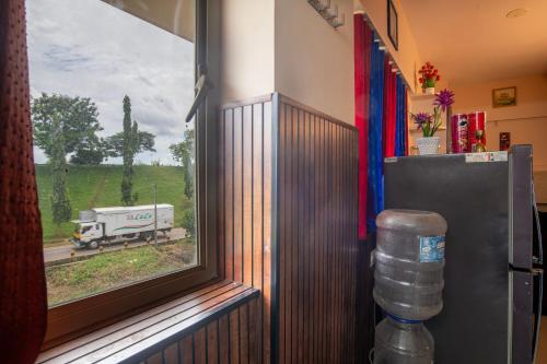 a window in a room with a truck on the road at Sancta Maria in Nedumbassery