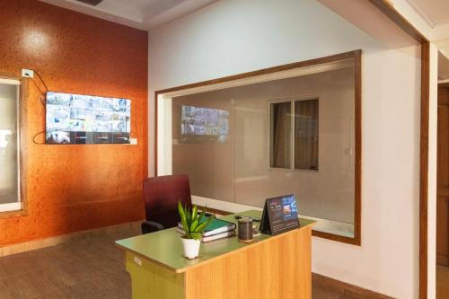 an office with a desk with a laptop on it at Sancta Maria in Nedumbassery