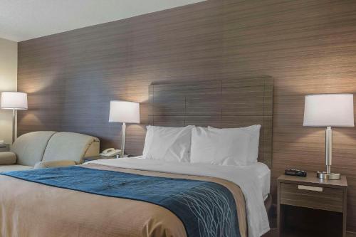 a hotel room with a large bed and two lamps at Comfort Inn in Lévis