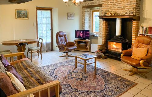 a living room with a couch and a fireplace at Amazing Home In Saint Martin Le Mault in Saint-Martin-le-Mault