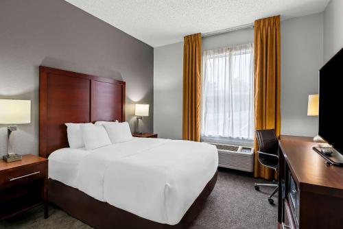 a hotel room with a large bed and a television at Comfort Inn & Suites Staunton in Staunton
