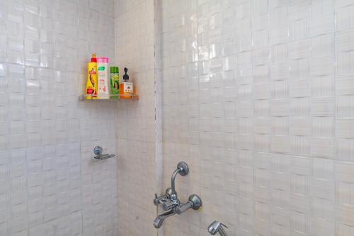 a bathroom with a shower stall with a sink at Sancta Maria in Nedumbassery