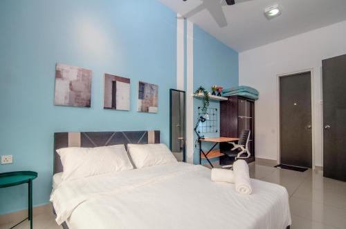 a bedroom with a white bed and a blue wall at DPULZE Residence By IdealHub in Cyberjaya