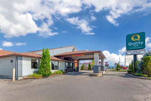 a quickys gas station with a sign in front of it at Quality Inn in Peterborough