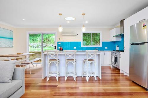 a kitchen with a large island with bar stools at Spacious 3BR Family Haven in Upper Ferntree Gully in Fern Tree Gully