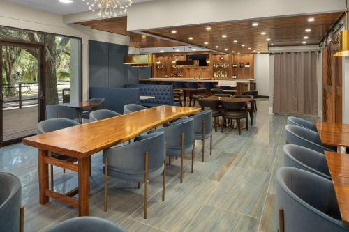 a restaurant with wooden tables and blue chairs at DoubleTree by Hilton Hilton Head Island in Hilton Head Island