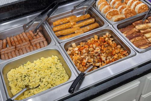 a buffet filled with different types of food in trays at DoubleTree by Hilton Hilton Head Island in Hilton Head Island