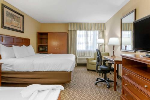 a hotel room with a bed and a desk at Comfort Inn Traverse City in Traverse City