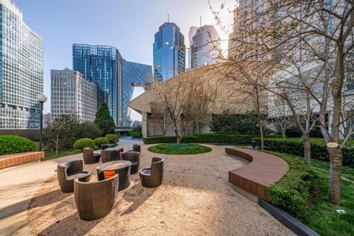 a park with benches and trees in a city at Kerry Hotel, Beijing by Shangri-La - 5 Kilometers to The Forbidden City in Beijing