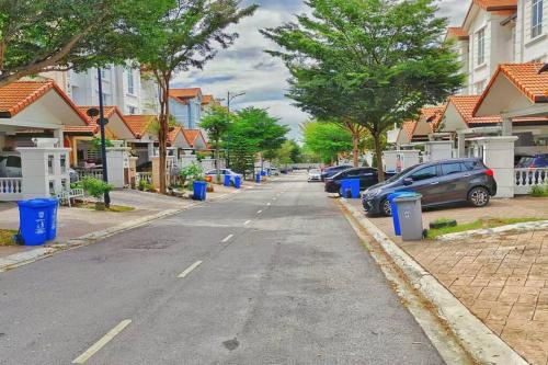 a street with houses and cars parked on the street at Setia Alam Convention Center Spacious House in Shah Alam